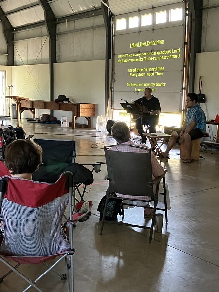 Randall Schieck Leads the Group in Worship Singing